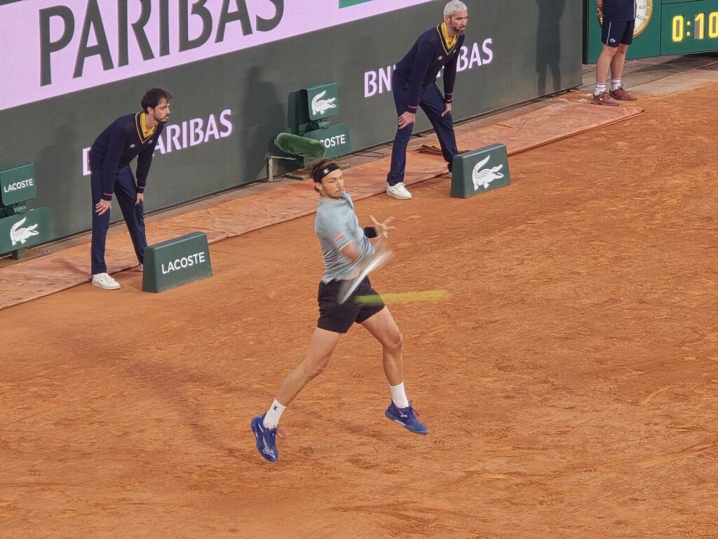 Jannik Sinner em meio a um golpe de forehand em quadra de saibro, em Roland Garros 2025 (Foto de arquivo: Jannik Sinner em Roland Garros 2025, antes de Monte Carlo 2026.)